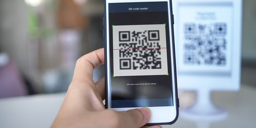 Women’s,Hand,Uses,A,Mobile,Phone,Application,To,Scan,Qr
